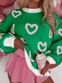 Detail view of green knit sweater with pink heart patterns and white ribbed cuffs - S / Green