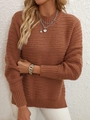 Detailed texture of dark orange knit sweater showing wave pattern and ribbed cuffs - Coffee