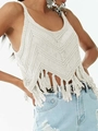 Close-up of white bohemian crochet tank top with intricate V-pattern and long fringe hem - S / Off White