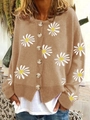 Detail of tan knit cardigan featuring white daisy embroidery and tortoiseshell buttons - Khaki