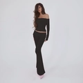 Detail view of the sleek black off-shoulder long sleeve top and flared pants set for women - S / Black