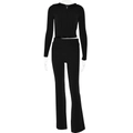 Detail of black ribbed knit two-piece set featuring hooded zip-up top and high waist pants - S / Black