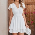 Elegant white V-neck mini dress with ruffled sleeves and tiered hem in a garden setting - White