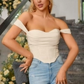 Ivory white corset top with ruched bust and asymmetric hem paired with blue jeans - XS / Apricot
