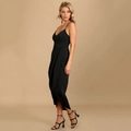 Detail of black V-neck slip dress featuring elegant waist pleats and asymmetric wrap hem - S / Black
