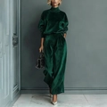 Detailed close-up showing the premium dark green velvet texture of the wide-leg trousers - Green