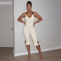 Detail of cream halter jumpsuit featuring ruffled leg cuffs and dark brown bow ties - S / Apricot