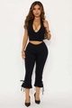 Detail of bow-knot lace-up hem on black halter neck top and cropped pants set - S / Black