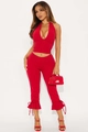 Detail of red halter V-neck top and cropped flared pants with ruffled lace-up cuffs - S / Red