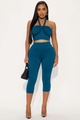 Detail of teal knit two-piece set featuring a halter crop top and high-waisted capris leggings - S / Blue