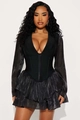 Elegante top tipo corsé negro con cuello en V, mangas largas transparentes y bajo con volantes - S / Negro