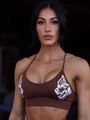 Detailed view of brown sports bra featuring thin straps and white wolf head print - S / Khaki Double Wolf Head / Khaki