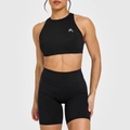 Close-up of black high-elasticity yoga set with racerback crop top and biker shorts - S / Black