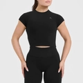 Close-up of black high-elasticity yoga crop top featuring a silver V-shaped logo on chest - Black