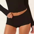 Detail of black yoga set featuring high-waisted shorts and long sleeve top with thumb holes - S / Shorts / Black