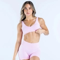 Detail view of pink U-shaped seamless sports bra with wide straps and high-waisted shorts - XS / Barbie Pink