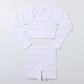 Detailed macro view of the seamless ribbed knit texture on white yoga set for women - White