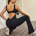 Backless yoga jumpsuit in black with wide straps and flared leg silhouette - L / Black