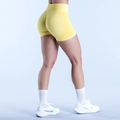Detail of high-waisted seamless yellow yoga shorts with scrunch butt lifting design - XS / Yellow