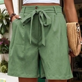Olive green high-waisted shorts with a bow-tie belt and relaxed A-line fit - Green