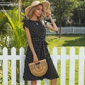 Short sleeve mid-length black dress with white polka dots and a waist tie ribbon - Black