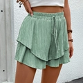 Women's light green high-waisted textured shorts with drawstring and ruffled hemline - Light Green