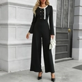 Elegante zwart-witte jumpsuit met lange mouwen, wijde pijpen en gouden knopen - S / Zwart
