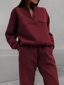 Detailed close-up of dark red tracksuit with half-zip sweatshirt and jogger pockets - Burgundy