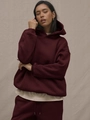 Women's burgundy oversized hoodie and jogger two-piece set in a warm studio setting - Red Brown