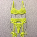 Detail of neon yellow mesh lingerie set with polka dots and garter belt on wire hanger - Fluorescent Green