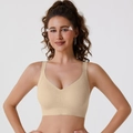 Close-up of nude seamless wireless bra with wide shoulder straps and soft support texture - M / Nude