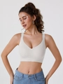 Close-up of beige seamless sports bra featuring breathable fabric and deep V-neck design - M / White