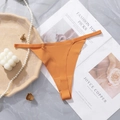 Orange seamless thong with thin elastic straps on elegant marble background decoration - Orange
