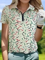 Detail of a women's beige golf polo shirt featuring colorful tee patterns and a zipper - S / Tops / White