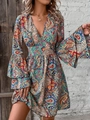Detailed view of bohemian paisley print texture on elegant V-neck flared bell sleeve dress - Rainbow