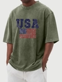 Close-up of vintage washed olive cotton T-shirt featuring a distressed USA flag print - Army Green