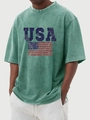 Detail of vintage washed green T-shirt featuring a distressed USA flag print on chest - Green