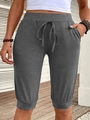 Detail view of dark grey high-waisted cropped joggers with drawstrings and side pockets - S / Bottoms / Gray