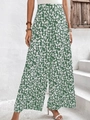 Detail einer hoch taillierten weiten Hose mit grünem Blumenmuster für den Sommerurlaub - S / Grün