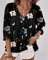 Detailed view of women's black floral chiffon shirt with V-neck and white buttons - Black