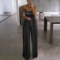 Close-up of elegant black sequin jumpsuit featuring beaded straps and deep V-neckline detail - Black and Gray