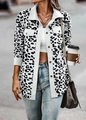 Detailed close-up of leopard print corduroy jacket fabric with button and pocket detail - White