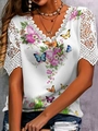 Detail of V-neck white top featuring floral lace sleeves and vibrant butterfly print - White Butterfly Floral Print
