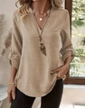 Close-up of khaki linen texture on women's V-neck top with buttoned rolled sleeves - Khaki