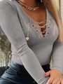 Detailed view of the V-neck with crisscross metal chains and heart charms on a long-sleeve top - Gray