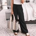 Dettaglio dei pantaloni a gamba larga a vita alta con coulisse elastica in nero - S / Nero