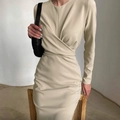Detail of elegant beige wrap dress with cross neckline and pleats at the waistline - S / Apricot