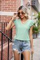 Detail of light green V-neck summer top with white lace trim and hollow-out crochet pattern - S / Tops / Pink