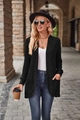 Detail of black ribbed knit cardigan featuring side patch pockets and soft textured fabric - Black