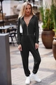 Close-up of black hooded long-sleeve jumpsuit with adjustable drawstrings and ribbed cuffs - S / Top And Bottom / Black